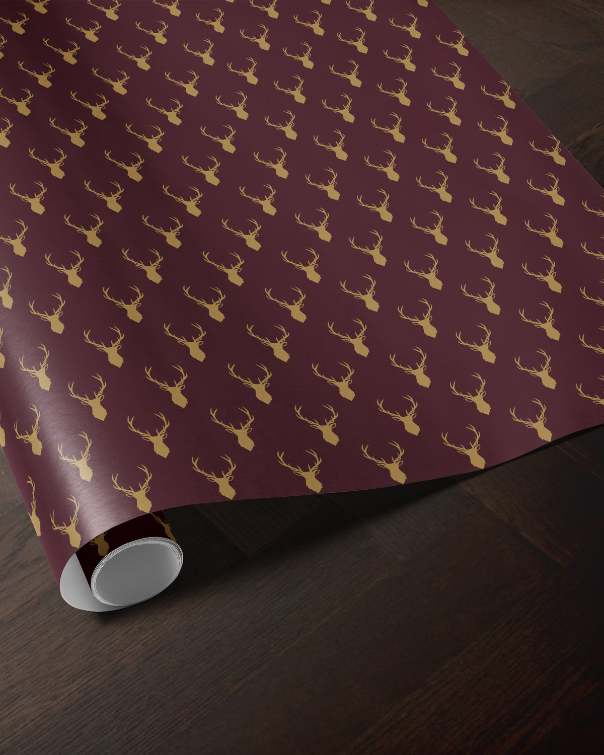 Burgundy reindeer wrapping paper roll with a golden antler pattern