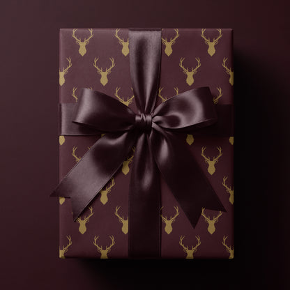 Burgundy reindeer wrapping paper featuring elegant golden antlers