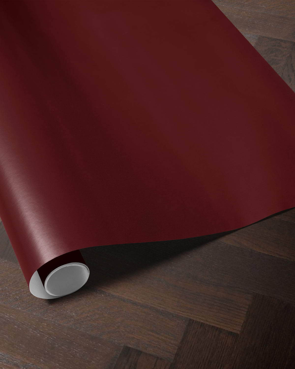Burgundy red wrapping paper roll showing the rich solid color and smooth paper finish