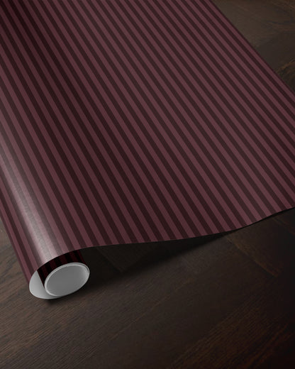 Burgundy striped wrapping paper roll showing the classic vertical stripe pattern