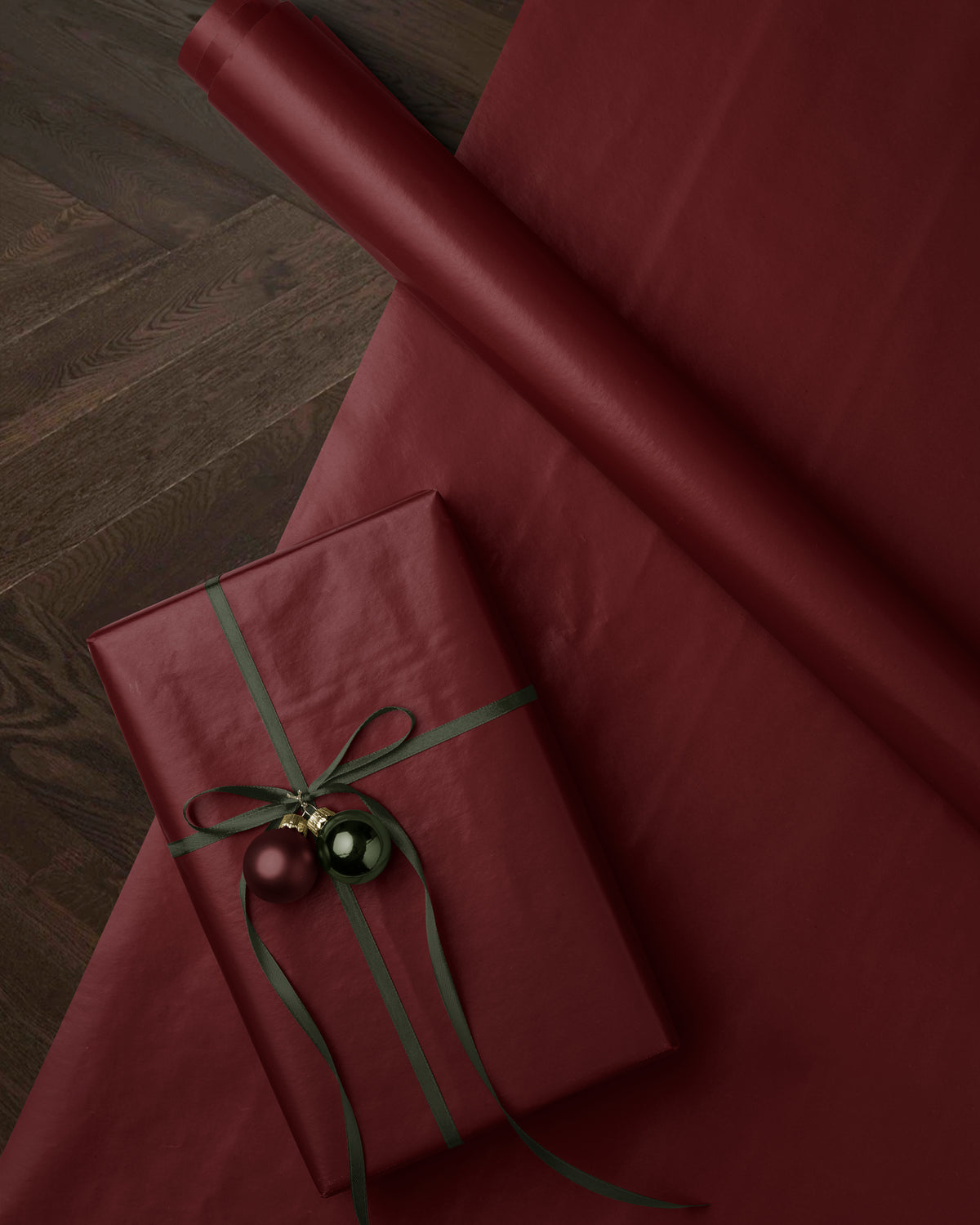 Close-up of solid burgundy red wrapping paper showing the deep red color