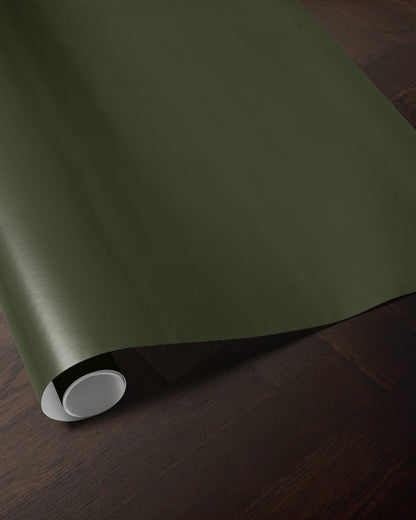 Dark green wrapping paper roll showing the rich solid color and smooth paper finish
