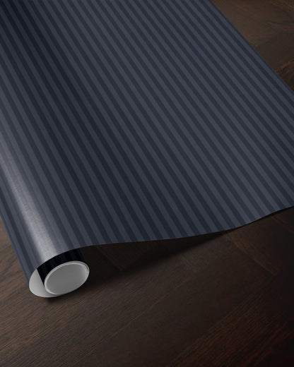 Navy blue striped wrapping paper roll showing the classic vertical stripe pattern
