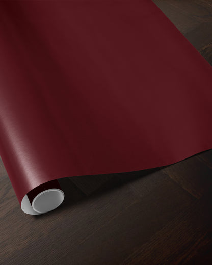 Red merlot wrapping paper roll showing the deep solid red color and smooth paper finish
