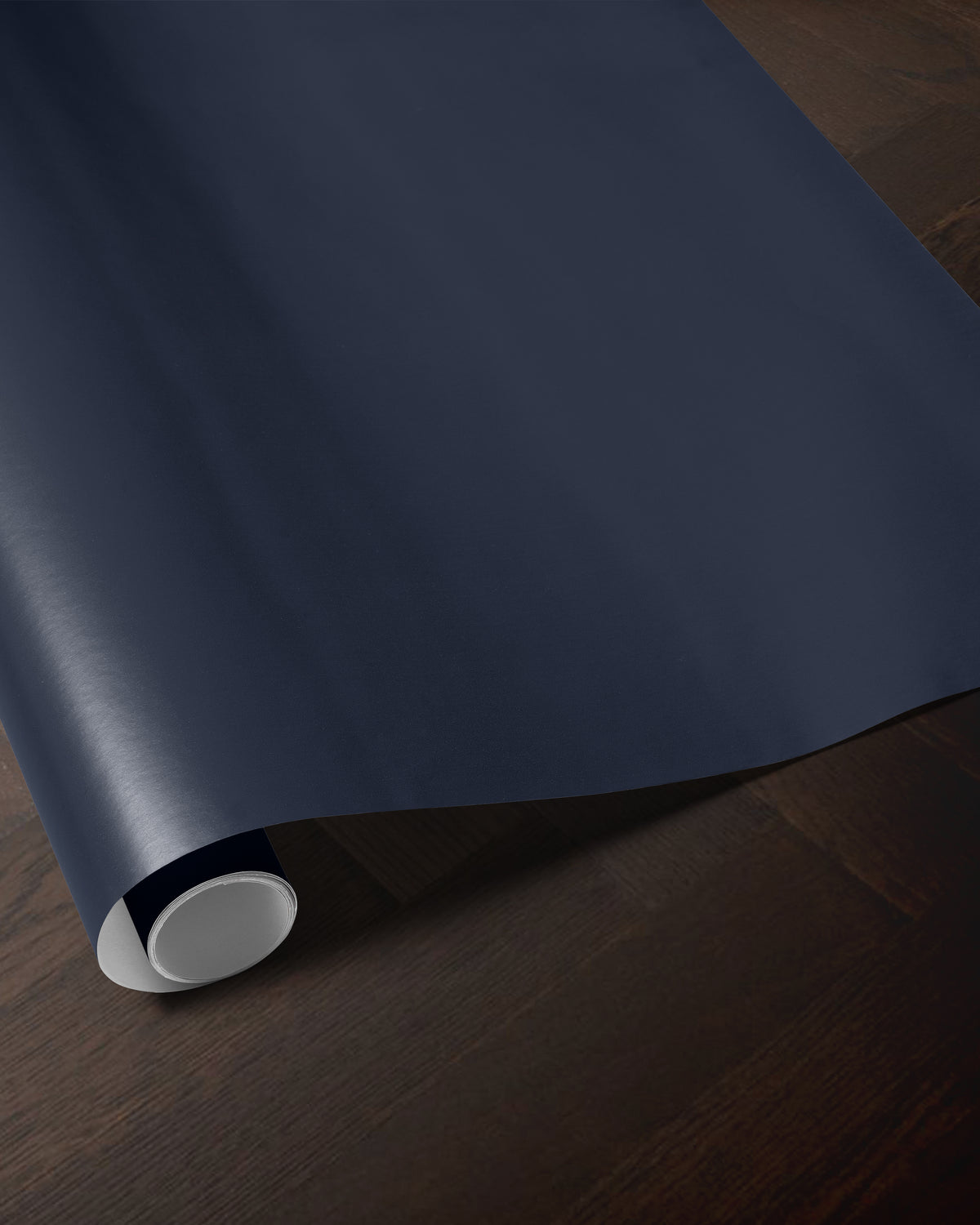 Navy blue wrapping paper roll showing the rich solid blue color and smooth paper finish