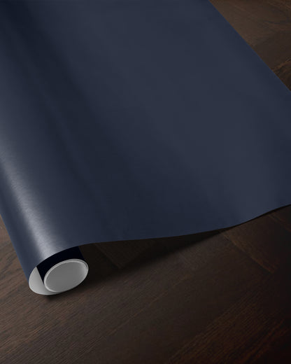 Navy blue wrapping paper roll showing the rich solid blue color and smooth paper finish