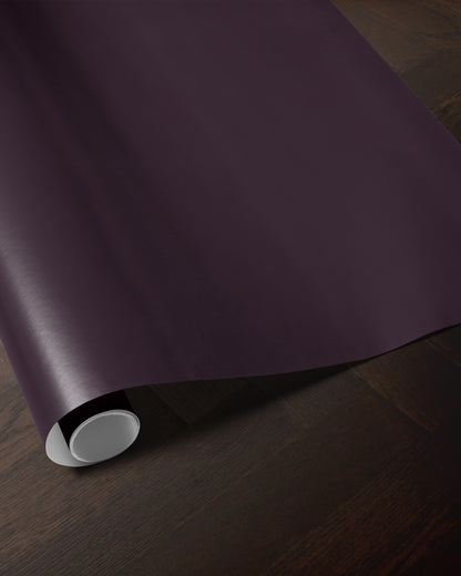 Plum wrapping paper roll showing the rich solid color and smooth paper finish
