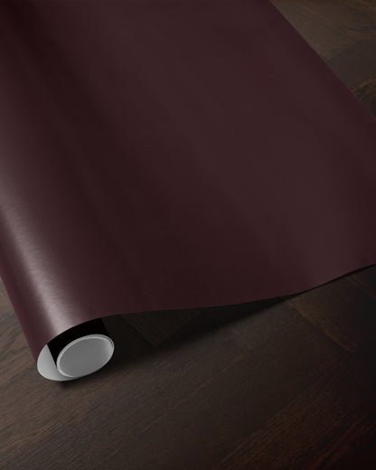 Dark burgundy wrapping paper roll showing the rich solid color and smooth paper finish