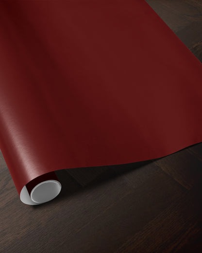 Wine red wrapping paper roll showing the rich solid red color and smooth paper finish